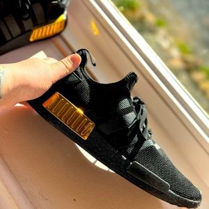 Black and gold size 10 NDM_1 adidas sneakers.